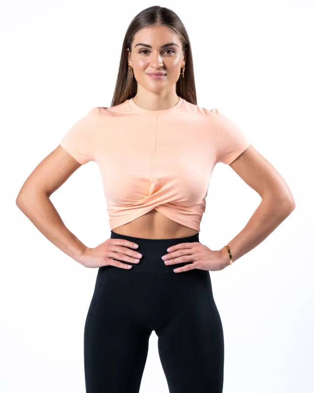 Evo Twist Crop - Cheeky Coral sold by Alphalete