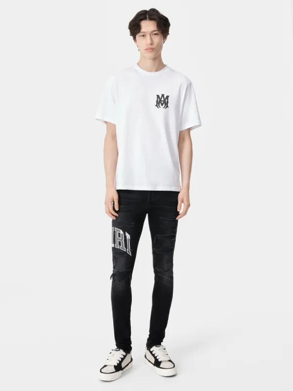 VARSITY LOGO REPAIR JEAN - Vintage Black sold by AMIRI