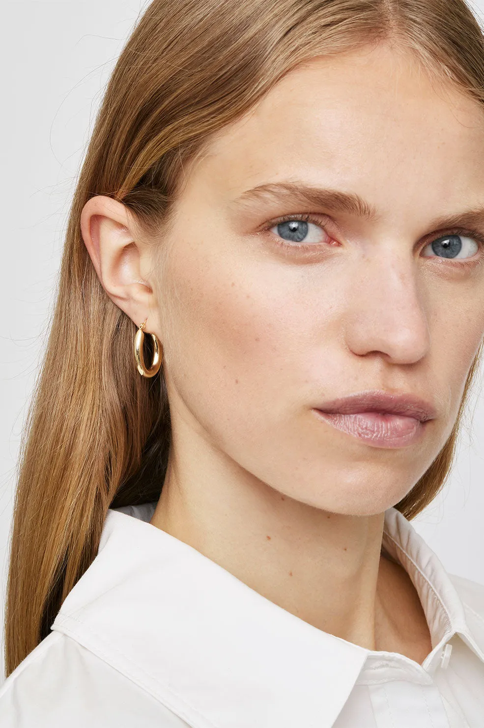 Small Tubular Oval Hoop Earrings - 14k Gold sold by Anine Bing product image thumbnail 2