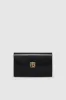 Elly Clutch - High-Shine Black sold by Anine Bing
