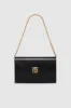 Elly Clutch - High-Shine Black sold by Anine Bing
