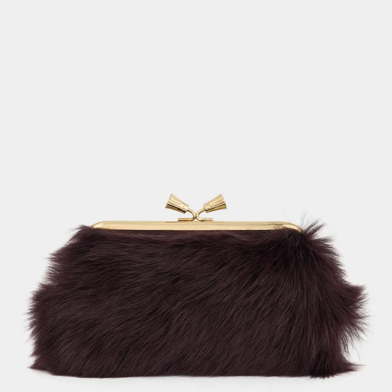 Maud Shearling Tassel Clutch sold by Anya Hindmarch