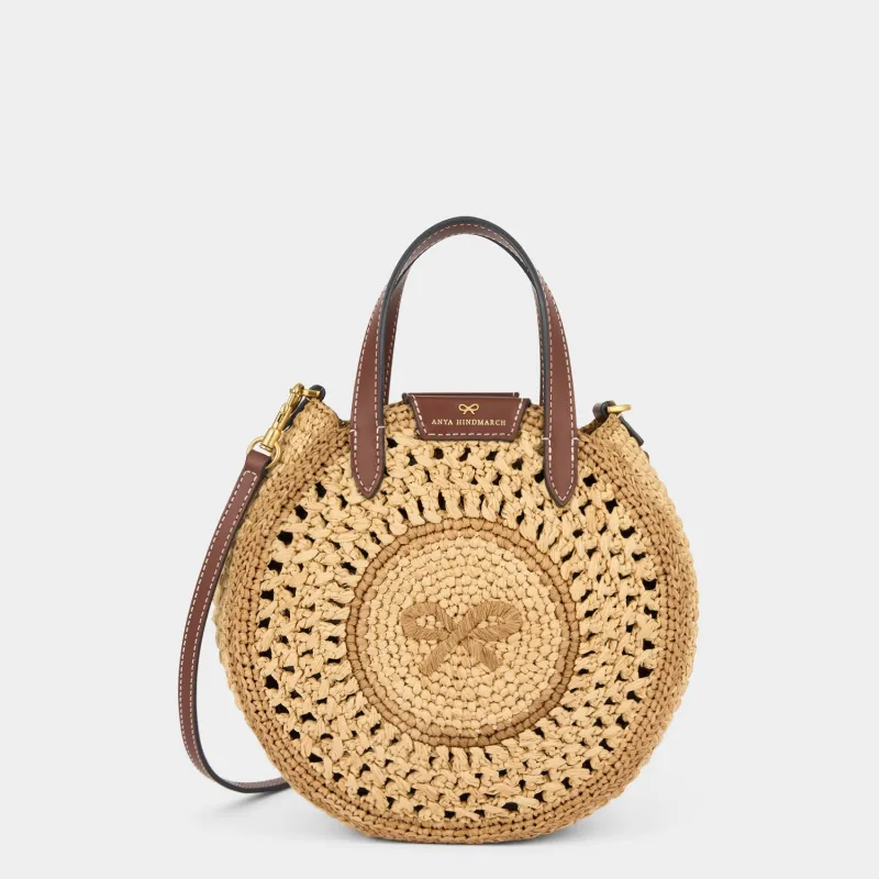 Raffia Small Round Bow Cross-body Tote sold by Anya Hindmarch