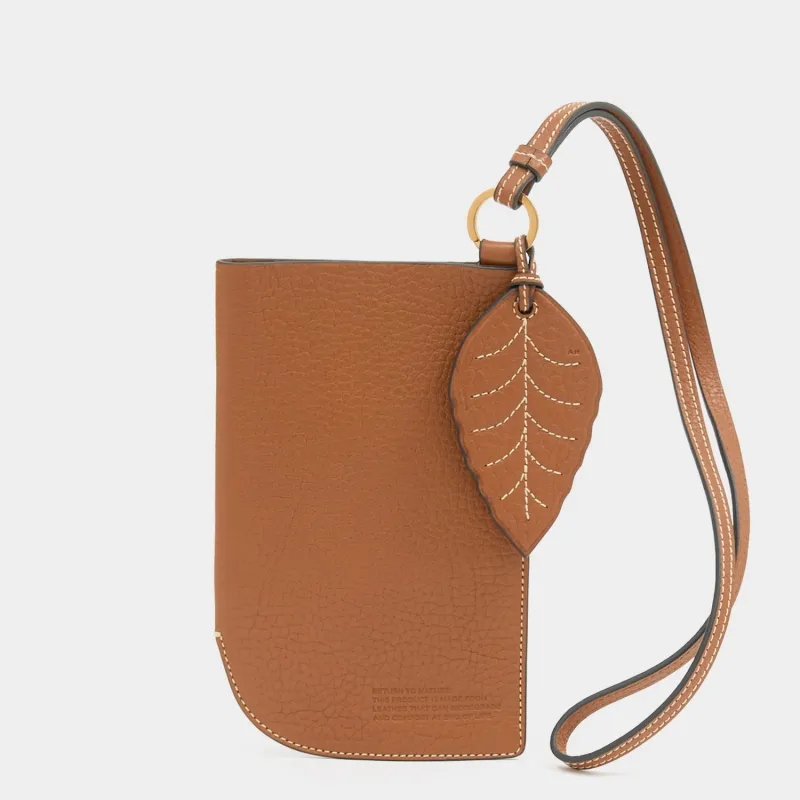 Return To Nature Strap Phone Pouch sold by Anya Hindmarch
