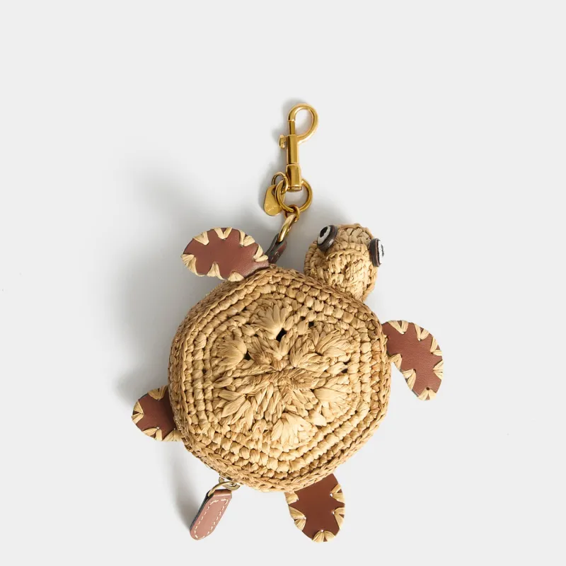 Raffia Turtle Earphone Pouch made by Anya Hindmarch