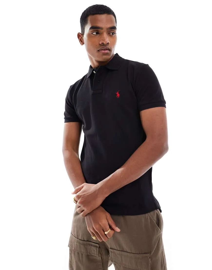 Polo Ralph Lauren slim fit pique polo with red player logo in washed black sold by ASOS