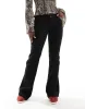 Bershka stretch high waisted flared trousers In black sold by ASOS