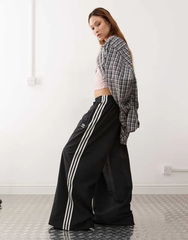 adidas Originals Adicolor wide leg track pants in black sold by ASOS