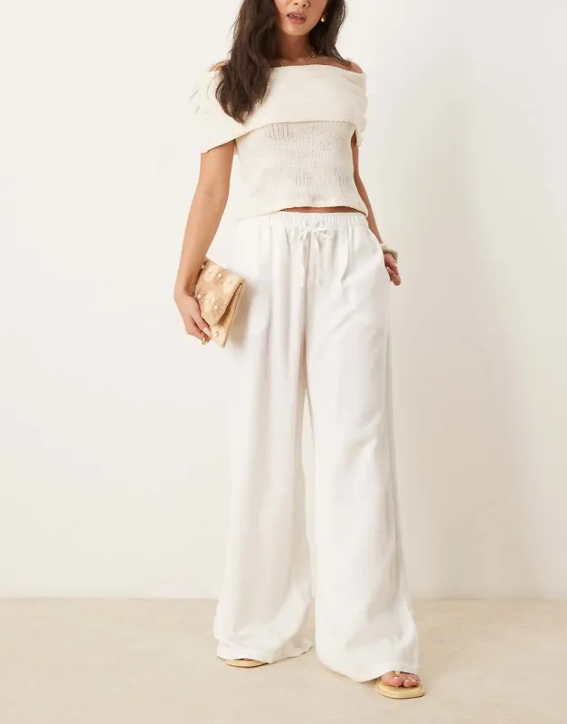 Stradivarius wide leg linen trousers in white sold by ASOS