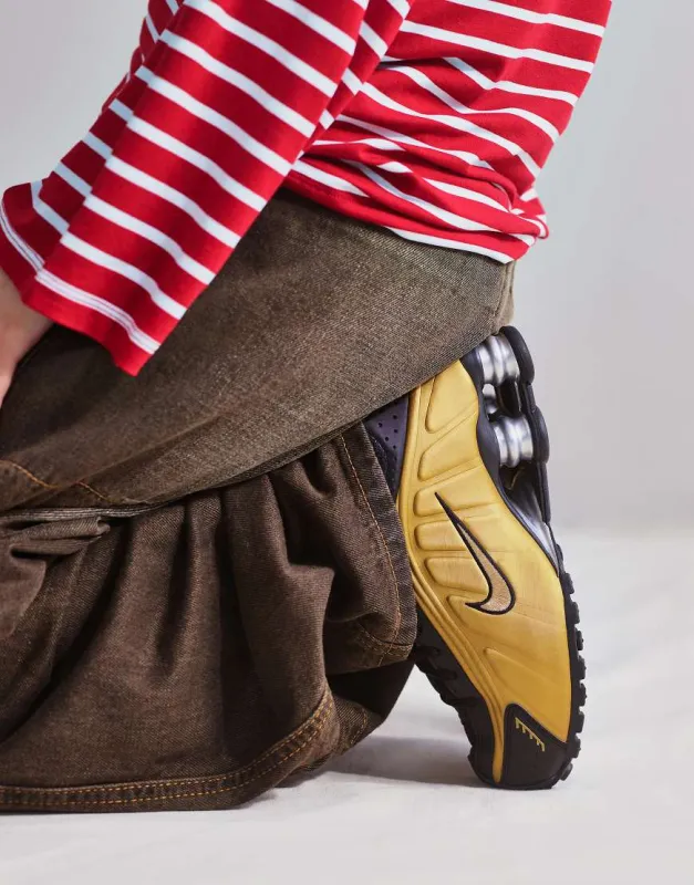 Nike Shox R4 trainers in gold and black sold by ASOS