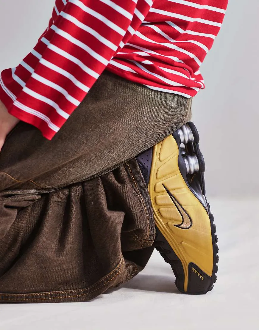 Nike Shox R4 trainers in gold and black sold by ASOS