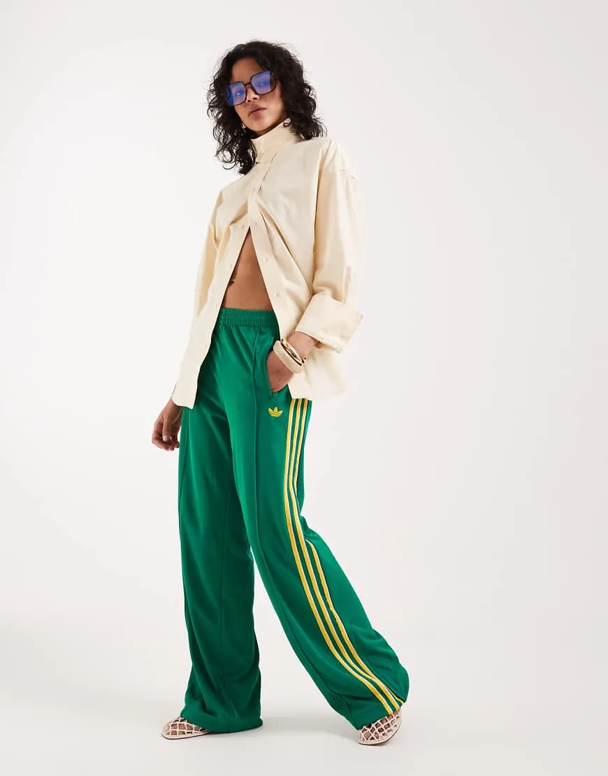 adidas Originals Firebird loose track pants in green and yellow sold by ASOS