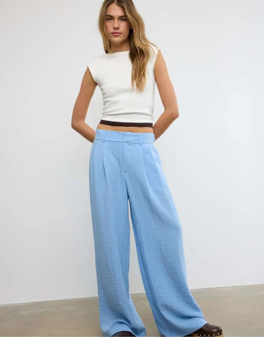 Stradivarius Rustic wide-leg trousers with adjustable buttons in blue sold by ASOS