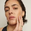 Lab Grown Green Emerald Baguette Huggie Earrings sold by Aurate