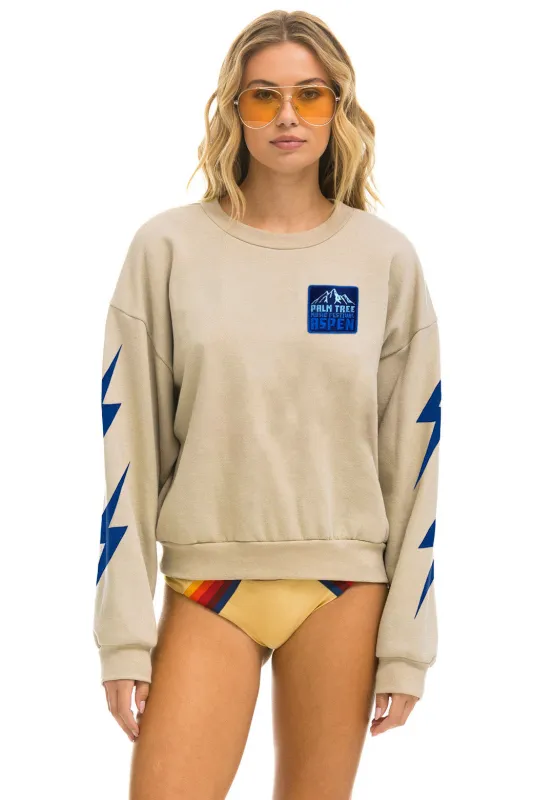 PALM TREE FESTIVAL ASPEN 2025 CREW SWEATSHIRT RELAXED - SAND made by Aviator Nation