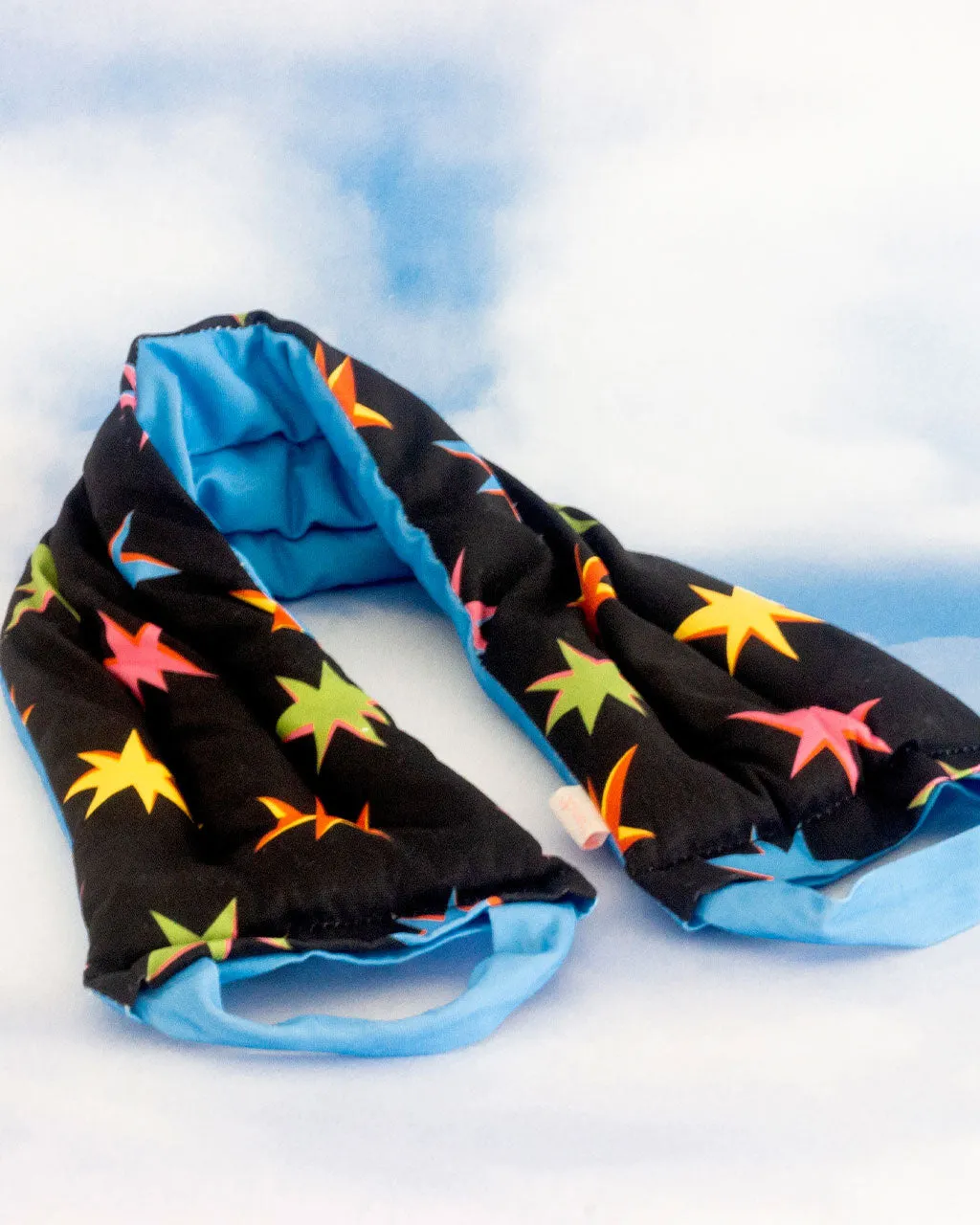 Hang In There! Weighted Neck Wrap - Starburst sold by ban.do