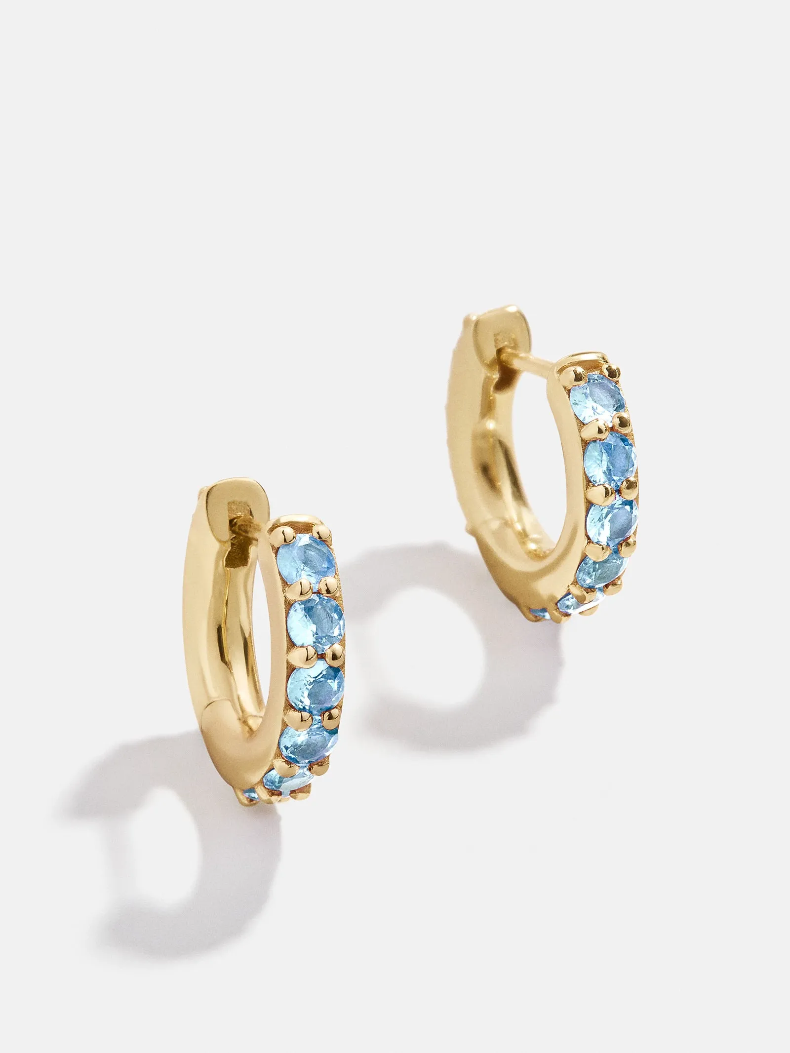 18K Gold Birthstone Huggie Earrings - Aquamarine sold by BaubleBar