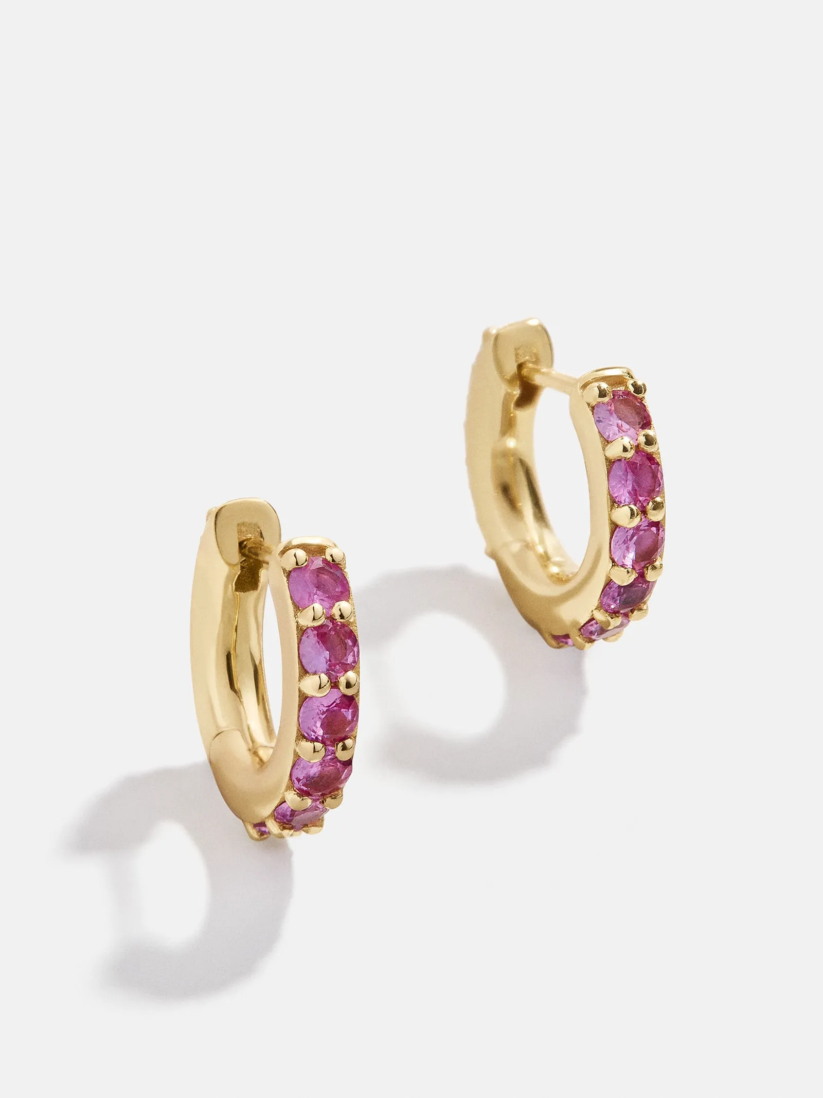 18K Gold Birthstone Huggie Earrings - Rose sold by BaubleBar