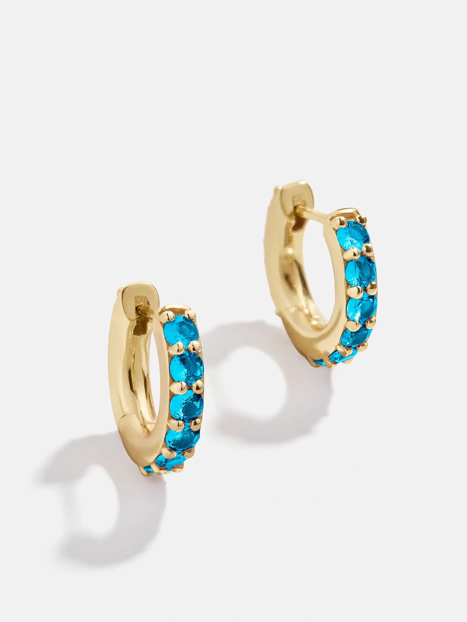 18K Gold Birthstone Huggie Earrings - Blue Zircon sold by BaubleBar