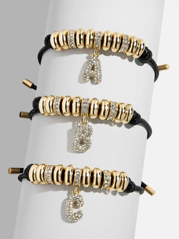 Natisha Initial Pull-Tie Bracelet - Gold/Black sold by BaubleBar