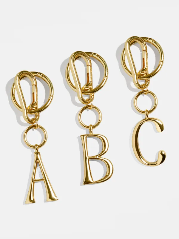 Gold Initial Enamel Bag Charm - A sold by BaubleBar