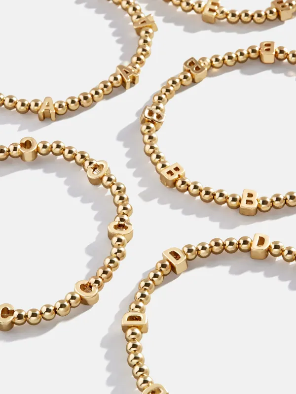 Repeating Initial Pisa Bracelet  - Gold sold by BaubleBar