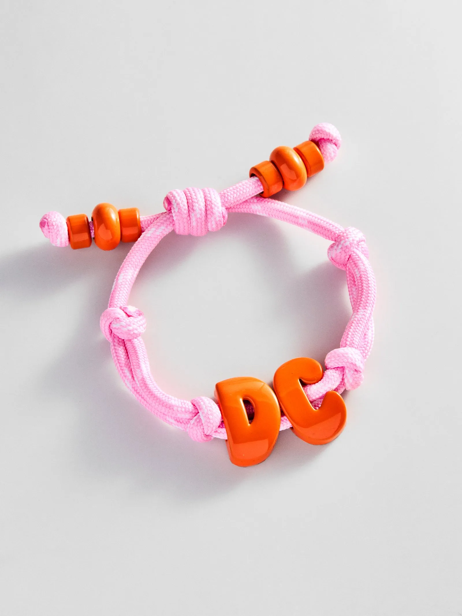 Knotty Enamel Initial Custom Bracelet - Pink/Orange Double Letter sold by BaubleBar
