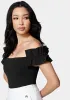 Knit Crepe Off Shoulder Ruffle Top sold by Bebe