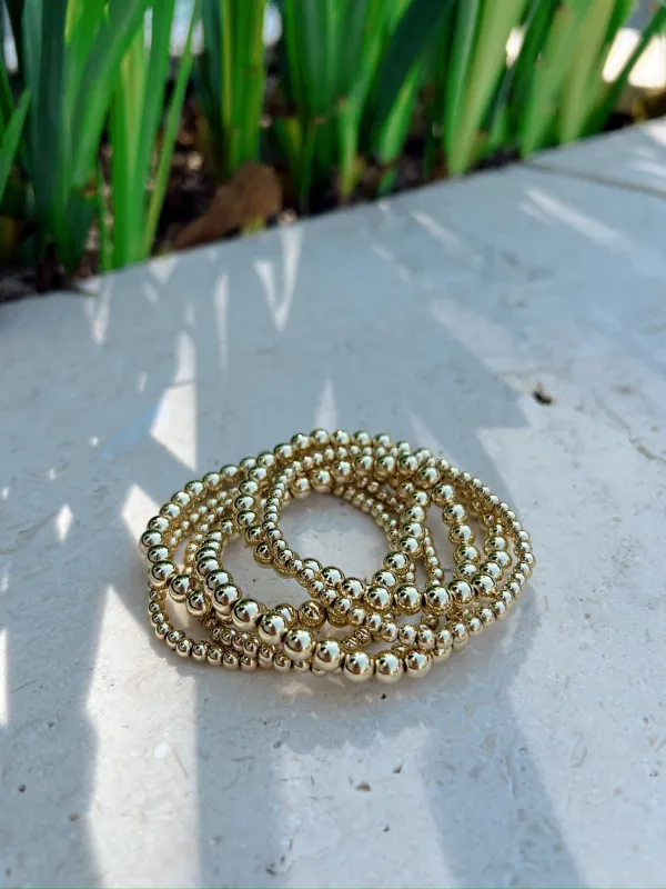 6 Piece Assorted Gold Bead Stretch Bracelet Set sold by Bella Rose boutique