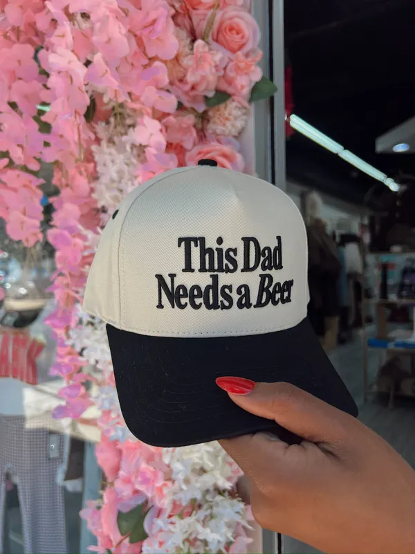 This Dad Needs A Beer Trucker Hat sold by Bella Rose boutique