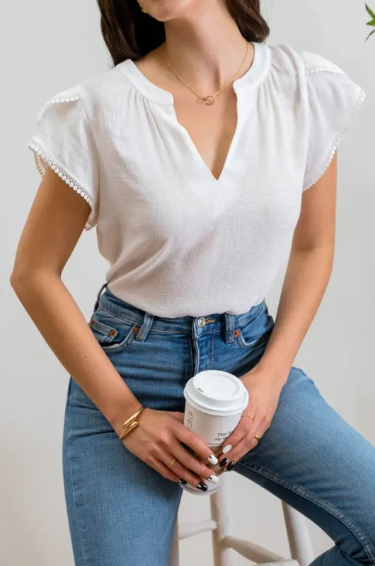 SPLIT NECK PETAL TASSEL SLEEVE BLOUSE sold by Blu Pepper