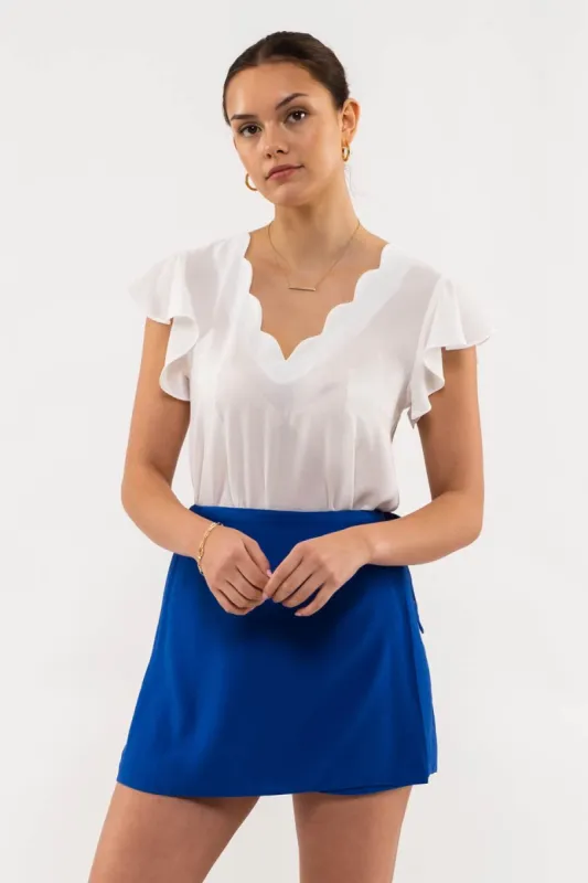 SCALLOPED V NECK WOVEN TOP sold by Blu Pepper