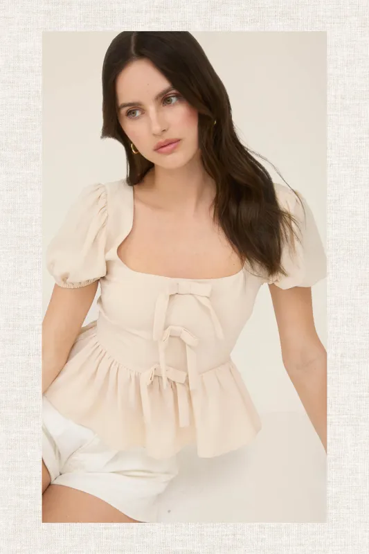 FRONT BOW DETAIL PUFF SLEEVE PEPLUM TOP sold by Blu Pepper