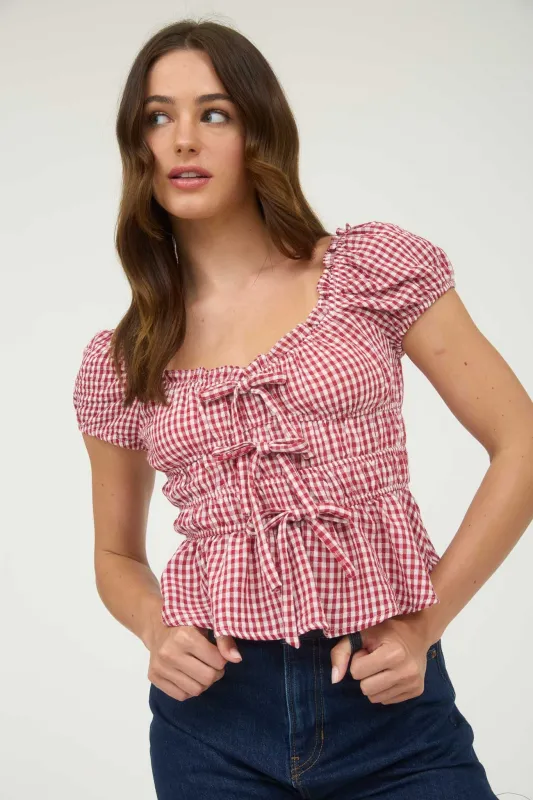 GINGHAM BOW DETAIL SHIRRED WAIST SHORT SLEEVE TOP sold by Blu Pepper