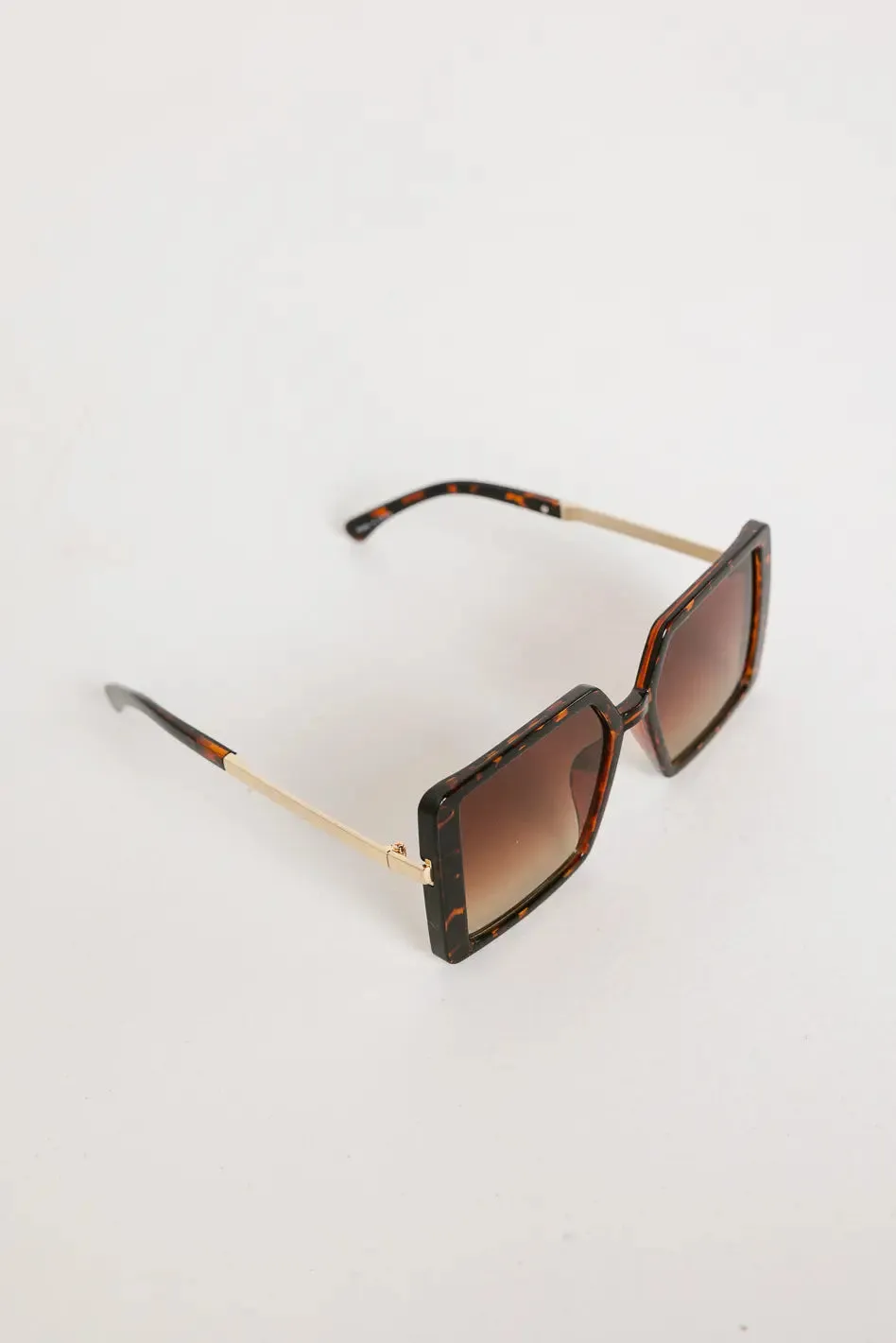 Elara Oversized Sunglasses in Brown sold by bohme