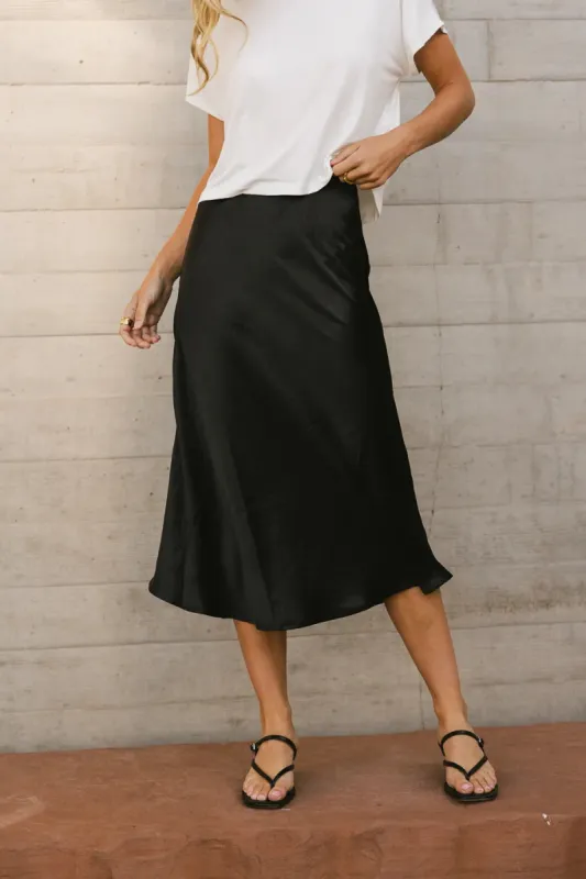 Lovinia Satin Midi Skirt in Black sold by bohme