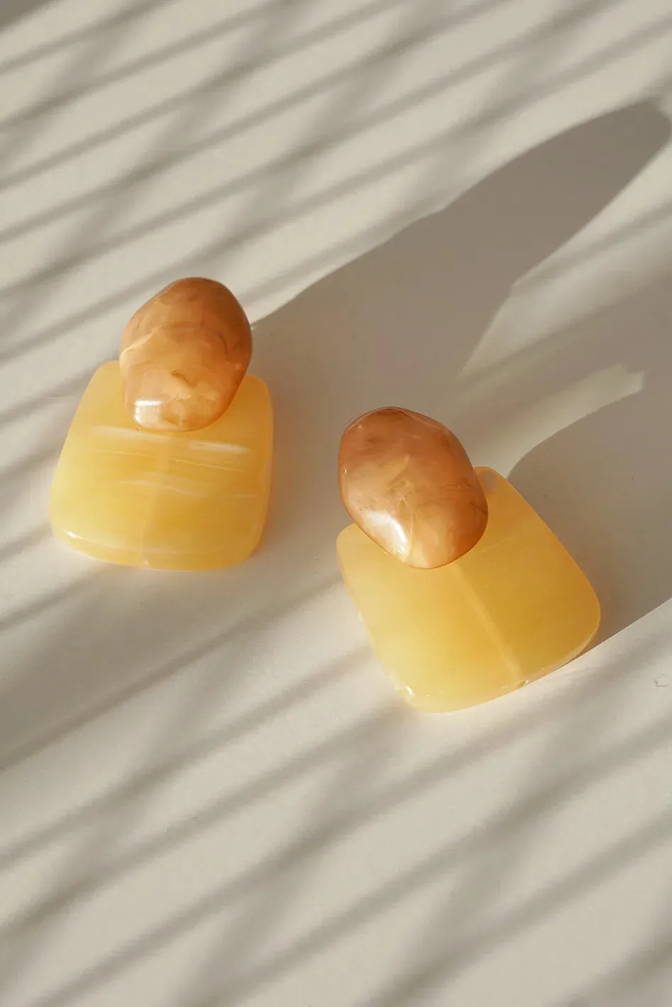 Ariana Earrings in Sand sold by bohme