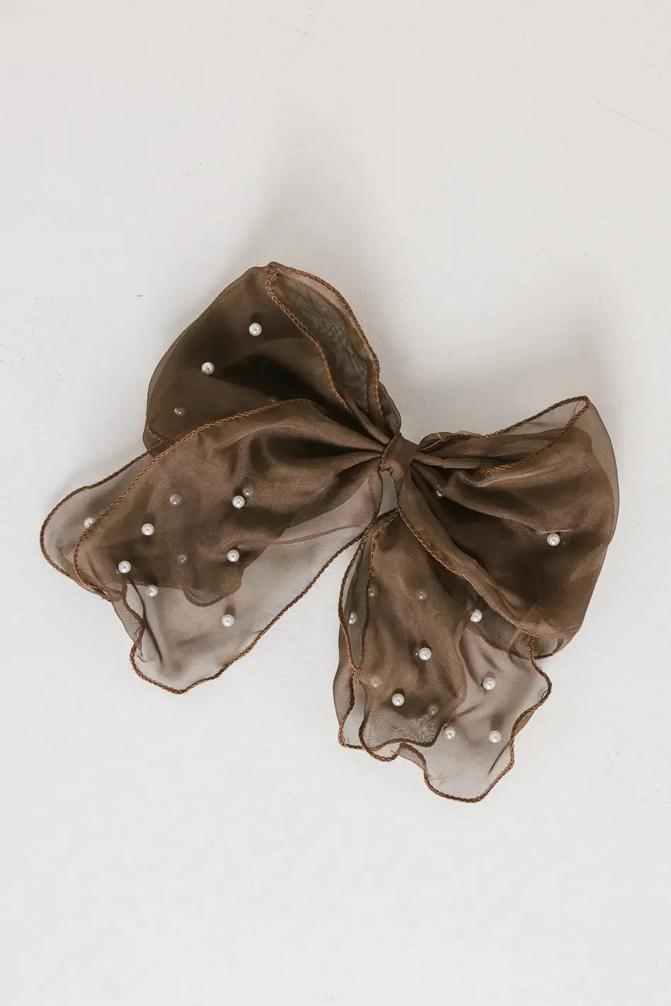 Pearl Bow Hair Clip in Brown sold by bohme