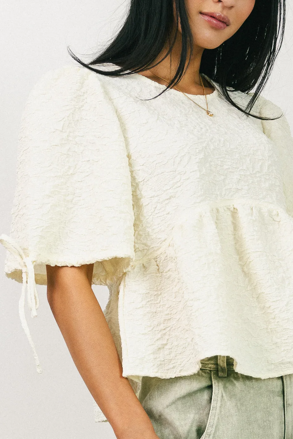 Alessia Peplum Top in Cream sold by bohme