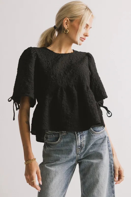 Alessia Peplum Top in Black sold by bohme