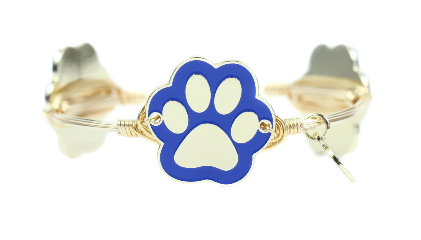 The Blue + Gold Paw Print Bangle Bracelet sold by Bourbon and Bowties