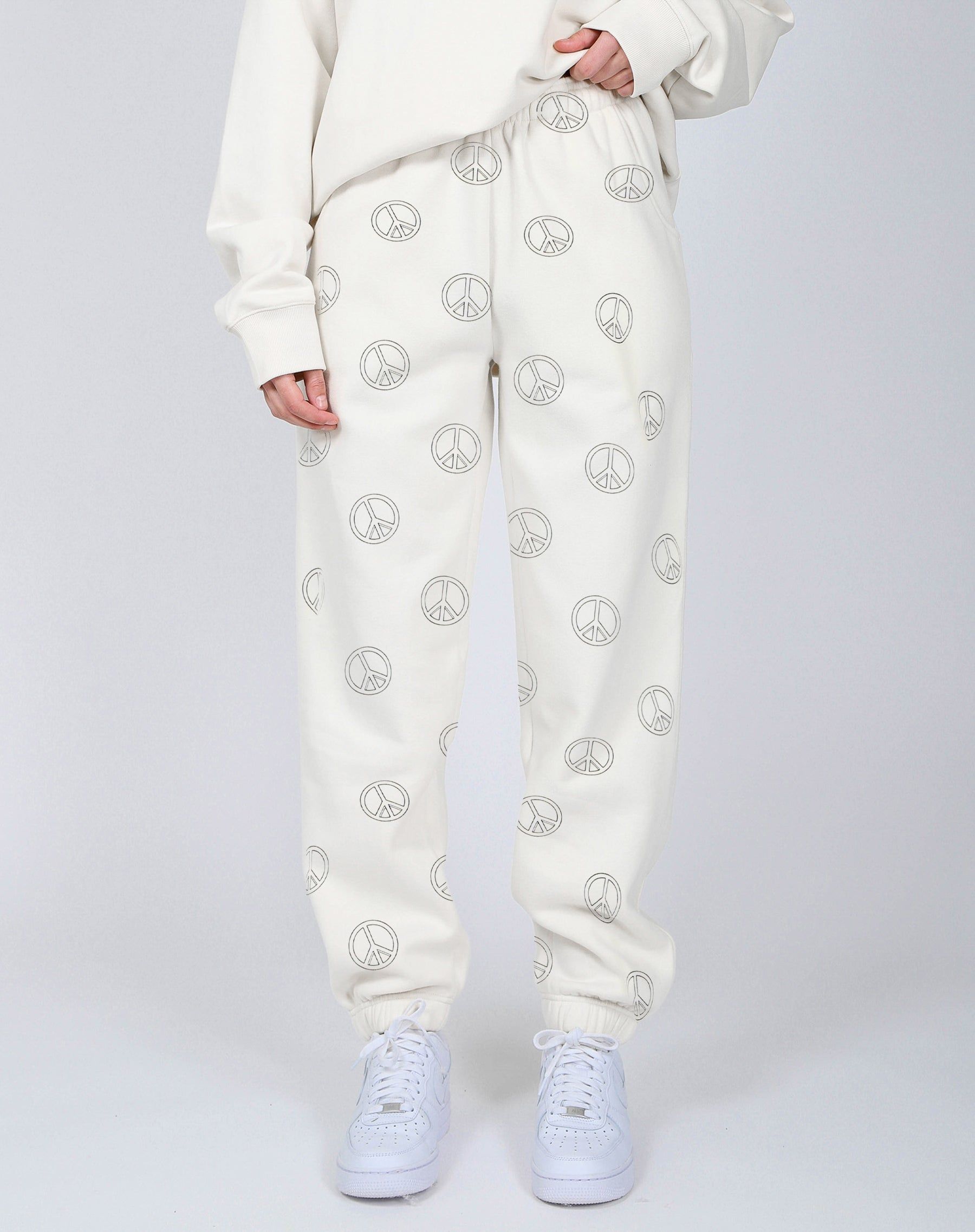 The "ALL OVER PEACE SIGN" Oversized Joggers | Almond Milk sold by Brunette The Label