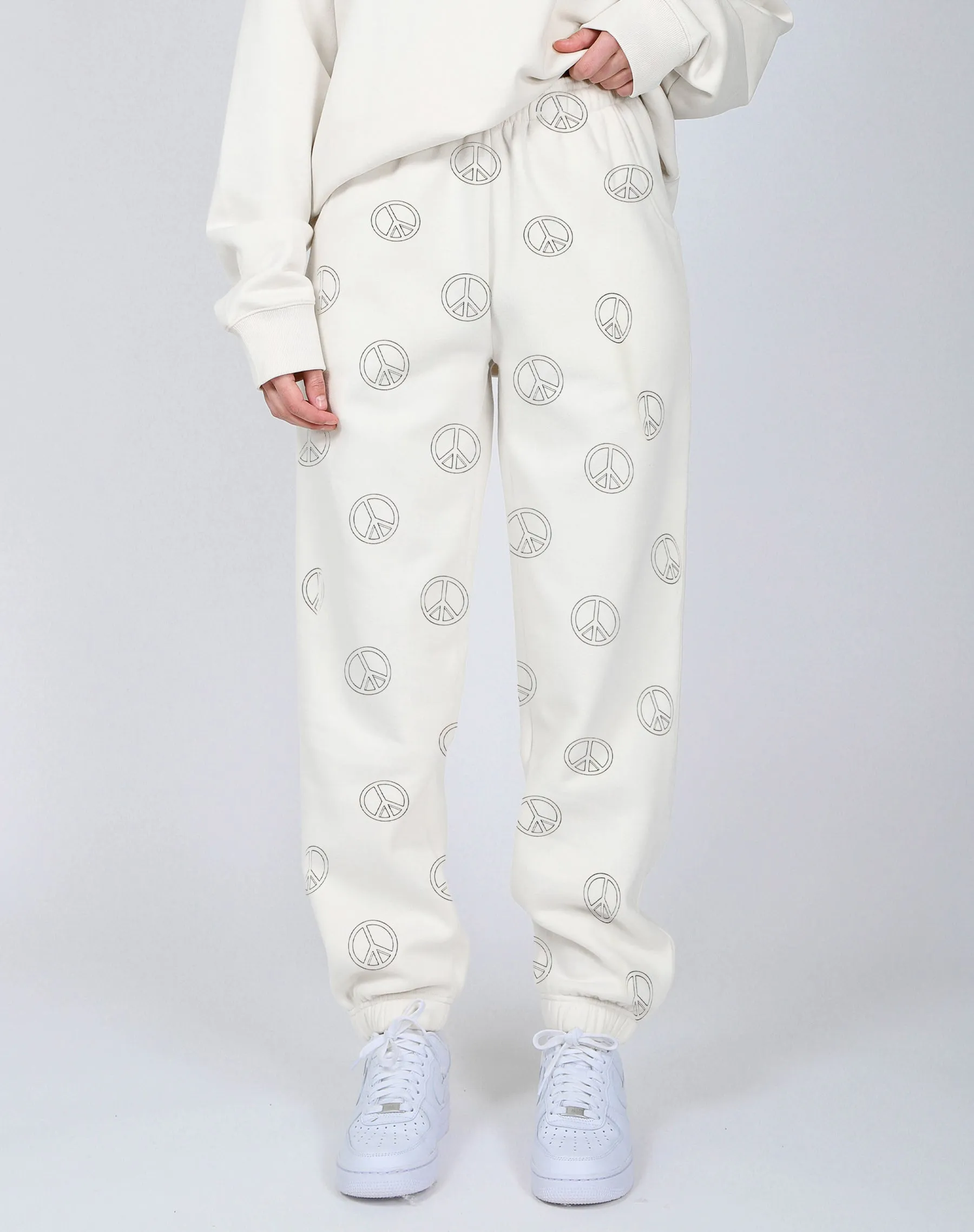 The "ALL OVER PEACE SIGN" Oversized Joggers | Almond Milk sold by Brunette The Label