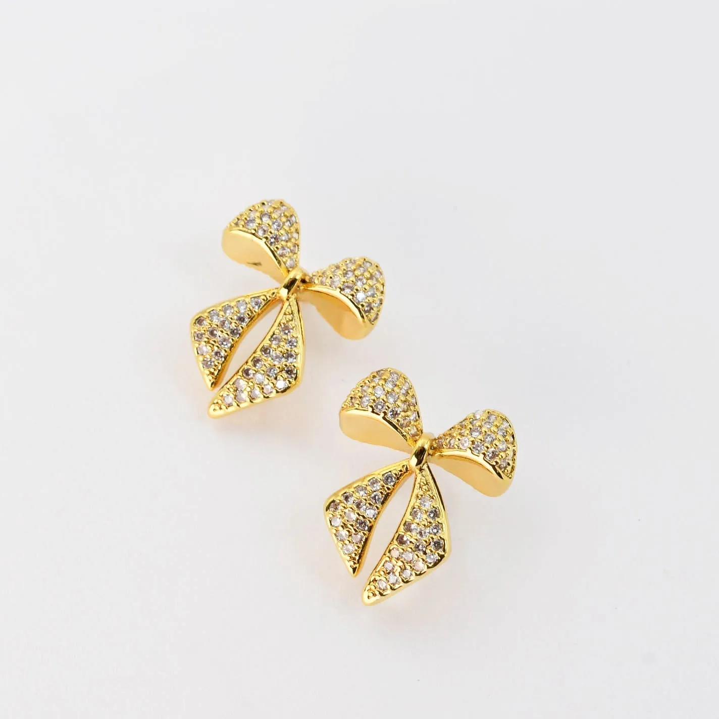 Twinkle Bow Gold Earrings sold by Buddy Love