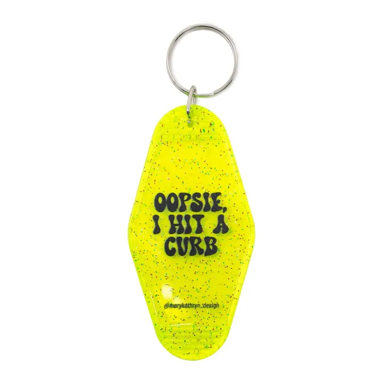Oopsie, I Hit A Curb Keychain (Neon Yellow Glitter) sold by Buddy Love