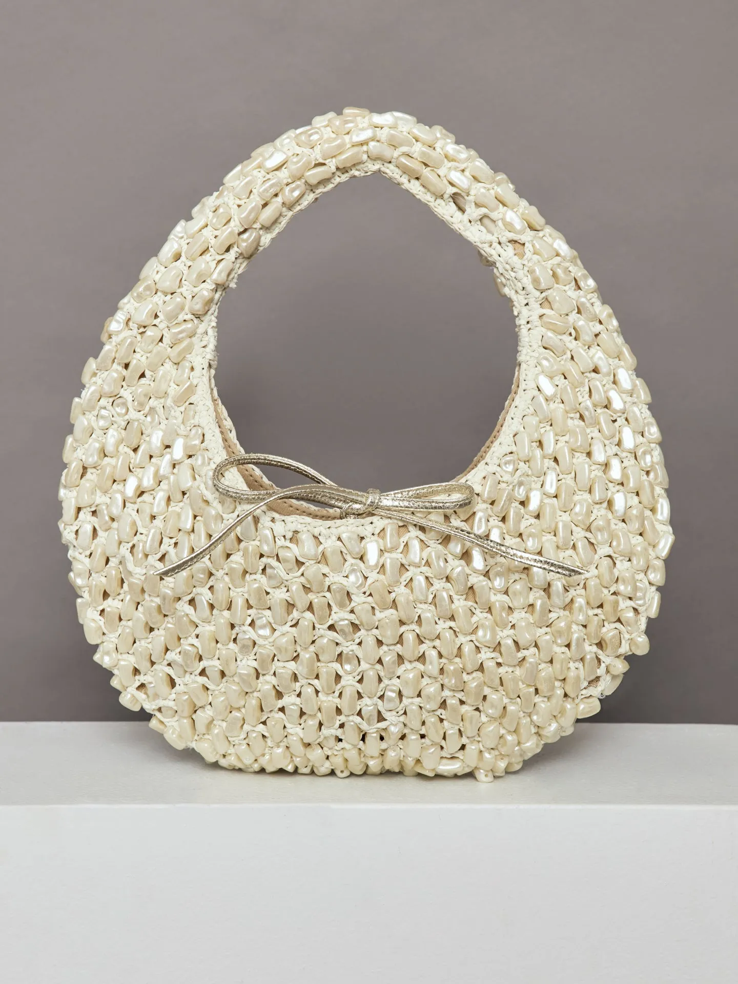 The Josie Tie Bag - Pearl and Raffia sold by Carbon38