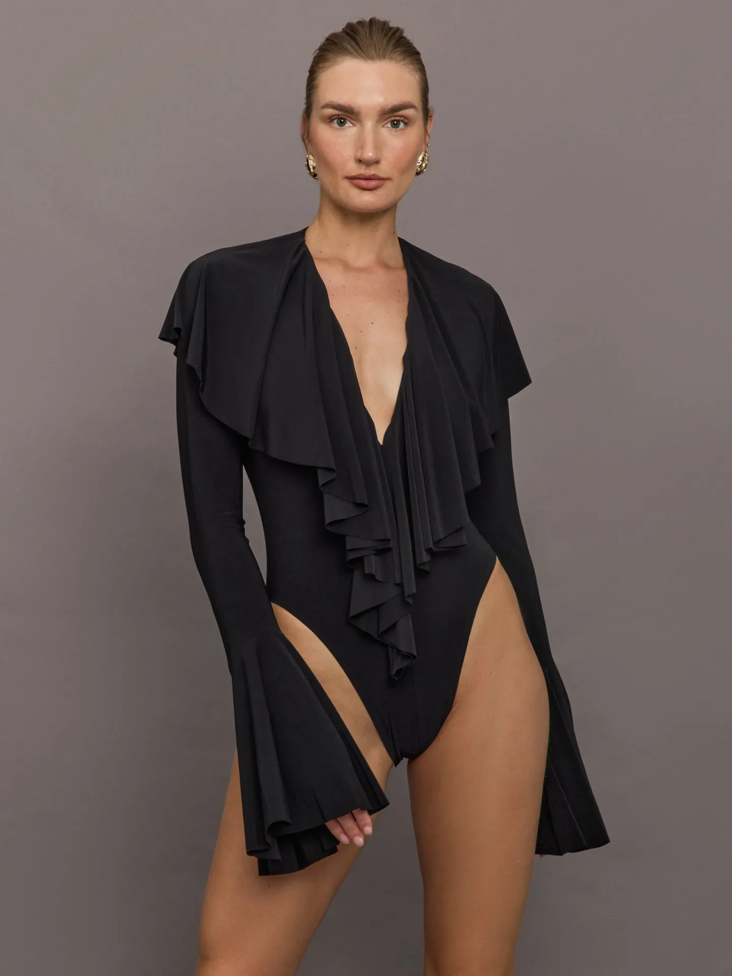 Long Sleeve Deep V Ruffle Bodysuit - Black sold by Carbon38