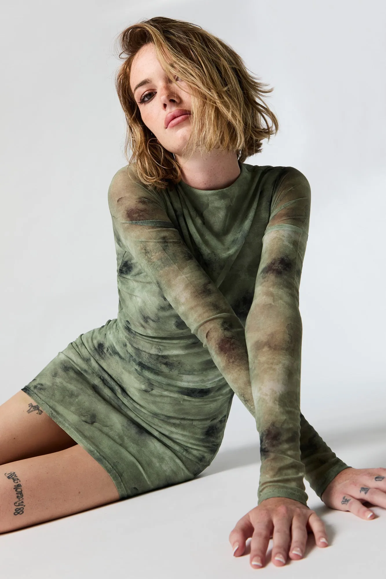 Mesh Ruched Long Sleeve Mini Dress sold by Charlotte Russe