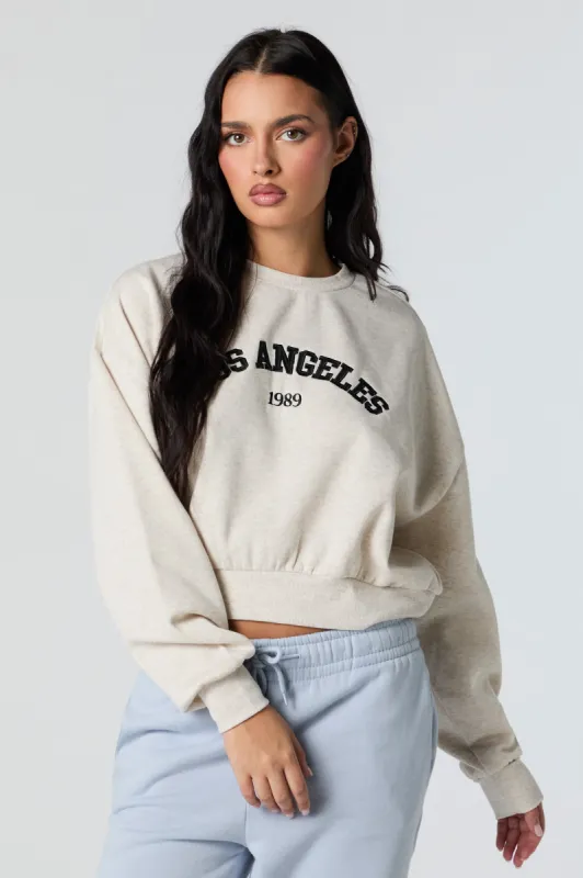 Los Angeles Embroidered Cropped Fleece Sweatshirt sold by Charlotte Russe