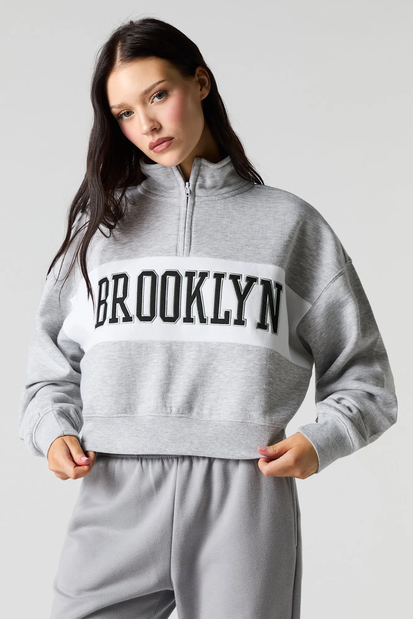 City Twill Embroidered Quarter Zip Fleece Sweatshirt sold by Charlotte Russe